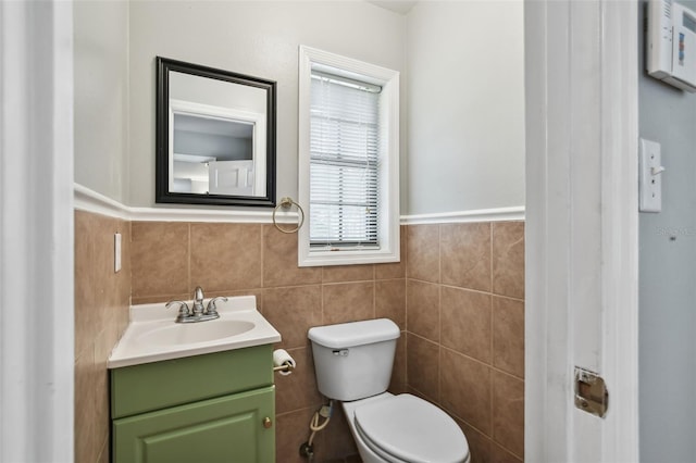 16 Pine Forest Dr, Haines City, FL 33844 - bathroom with tile walls, vanity, and a wainscoted wall