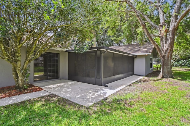 16 Pine Forest Dr, Haines City, FL 33844 - rear view of property with a sunroom, a yard, and stucco siding