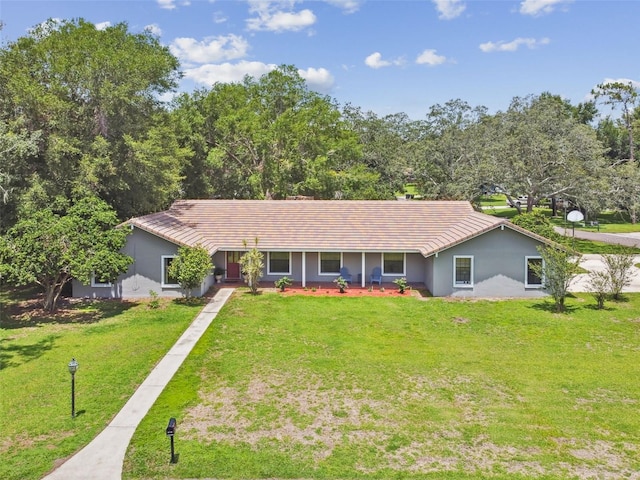 16 Pine Forest Dr, Haines City, FL 33844 - ranch-style home with a front lawn, a tile roof, and stucco siding
