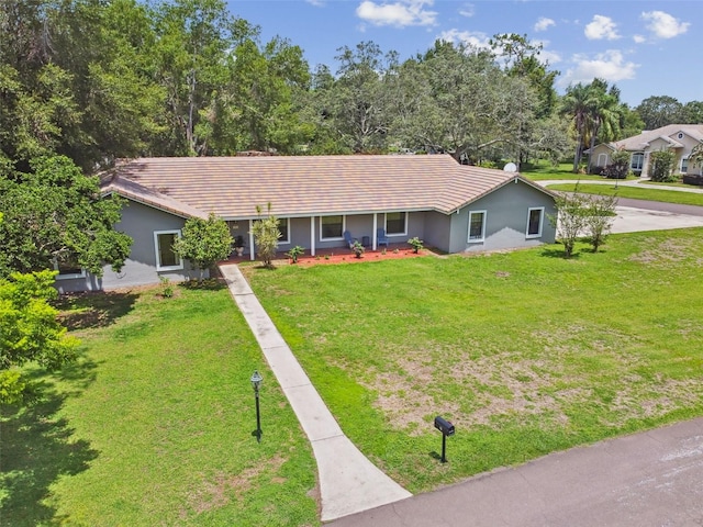 16 Pine Forest Dr, Haines City, FL 33844 - ranch-style home with stucco siding, a front lawn, a tiled roof, and a porch