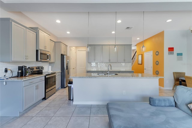 5103 Jones Rd, Saint Cloud, FL 34771 - kitchen featuring stainless steel appliances, gray cabinetry, light tile patterned flooring, decorative backsplash, and recessed lighting