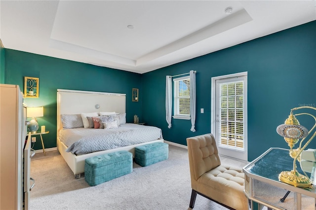5103 Jones Rd, Saint Cloud, FL 34771 - carpeted bedroom featuring a tray ceiling and baseboards