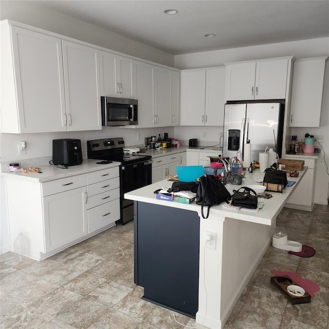 312 Lake Smart Cir, Winter Haven, FL 33881 - kitchen featuring stainless steel microwave, range with electric cooktop, refrigerator with ice dispenser, light countertops, and white cabinetry