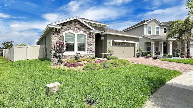 148 Whirlaway Dr, Davenport, FL 33837 - view of front facade featuring stone siding, an attached garage, driveway, and stucco siding