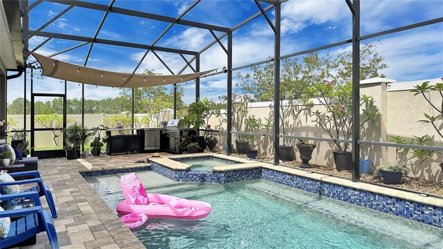 148 Whirlaway Dr, Davenport, FL 33837 - view of swimming pool with a patio, area for grilling, a pool with connected hot tub, and a lanai