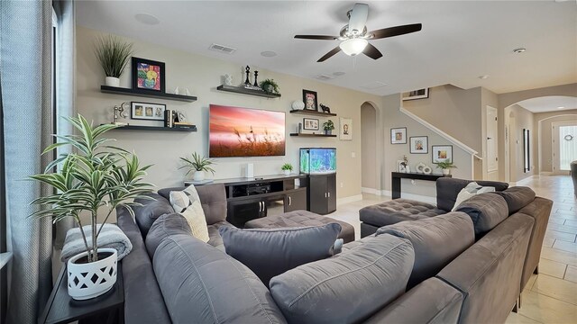 148 Whirlaway Dr, Davenport, FL 33837 - living area featuring arched walkways, a ceiling fan, and light tile patterned floors