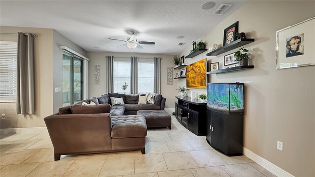 148 Whirlaway Dr, Davenport, FL 33837 - living room featuring ceiling fan and a textured ceiling