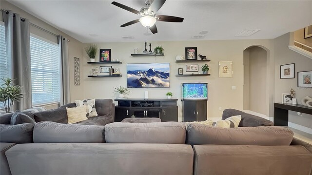 148 Whirlaway Dr, Davenport, FL 33837 - living room with arched walkways and ceiling fan