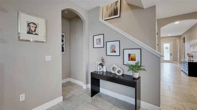 148 Whirlaway Dr, Davenport, FL 33837 - hallway with arched walkways and recessed lighting