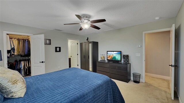 148 Whirlaway Dr, Davenport, FL 33837 - bedroom featuring light colored carpet, ceiling fan, a spacious closet, and a closet