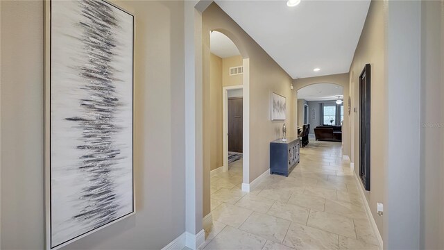 148 Whirlaway Dr, Davenport, FL 33837 - hall with arched walkways, recessed lighting, and light marble finish flooring