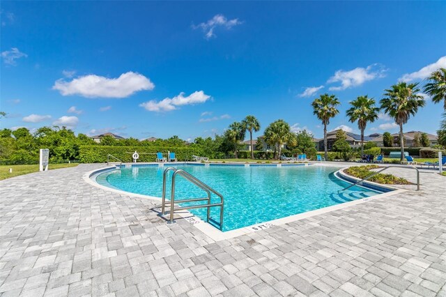 148 Whirlaway Dr, Davenport, FL 33837 - community pool with a patio