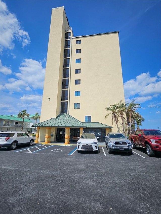 3647 S Atlantic Ave Unit 3C, Daytona Beach, FL 32118 - view of building exterior with uncovered parking