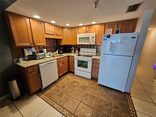 3647 S Atlantic Ave Unit 3C, Daytona Beach, FL 32118 - kitchen featuring white appliances, a sink, decorative backsplash, recessed lighting, and light stone counters