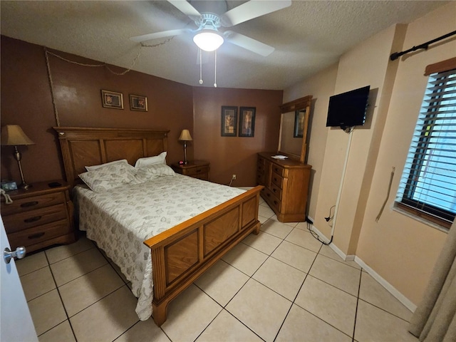 3647 S Atlantic Ave Unit 3C, Daytona Beach, FL 32118 - bedroom featuring a textured ceiling, light tile patterned flooring, a ceiling fan, and baseboards