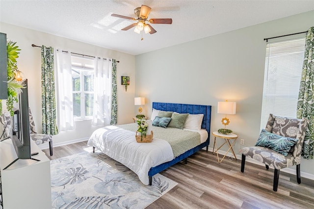 8491 Oasis Key Cv, Kissimmee, FL 34747 - bedroom with wood finished floors, baseboards, and ceiling fan