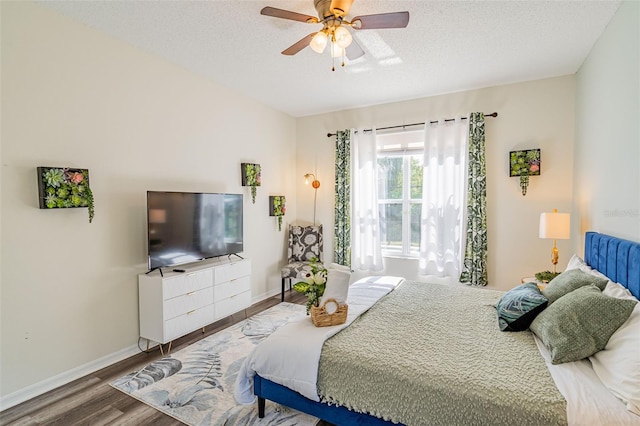 8491 Oasis Key Cv, Kissimmee, FL 34747 - bedroom with wood finished floors, baseboards, a textured ceiling, and a ceiling fan