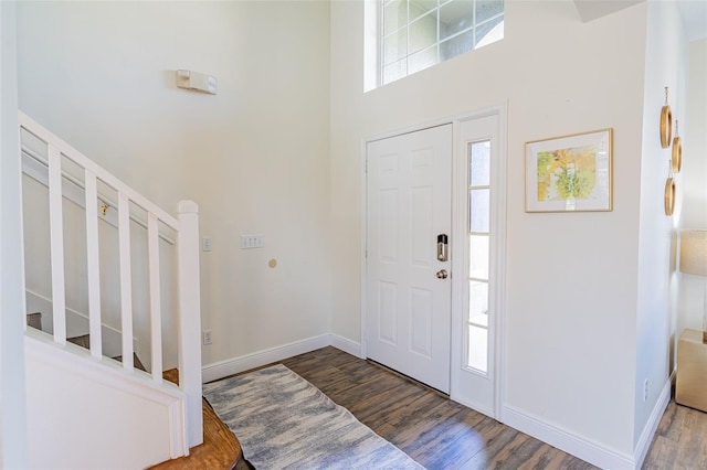 8491 Oasis Key Cv, Kissimmee, FL 34747 - entrance foyer featuring wood finished floors, a towering ceiling, baseboards, and stairs