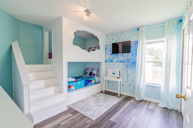 8491 Oasis Key Cv, Kissimmee, FL 34747 - bedroom with a textured ceiling, wood finished floors, multiple windows, and ceiling fan