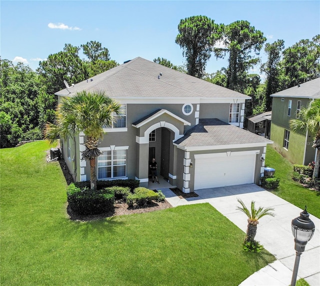 8491 Oasis Key Cv, Kissimmee, FL 34747 - view of front of house with stucco siding, driveway, an attached garage, a front yard, and central AC