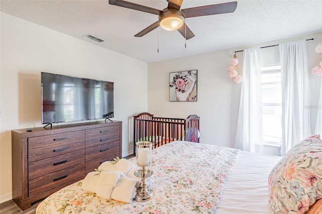 8491 Oasis Key Cv, Kissimmee, FL 34747 - bedroom with a textured ceiling, wood finished floors, and ceiling fan