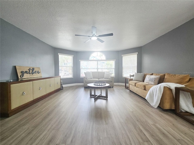 2735 N Poinciana Blvd Unit 95, Kissimmee, FL 34746 - living room with wood finished floors, a ceiling fan, a textured ceiling, and baseboards