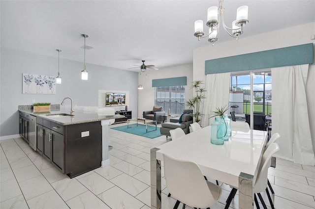 1578 Slice Way, Davenport, FL 33896 - kitchen with light marble finish flooring, a ceiling fan, a chandelier, and light stone countertops