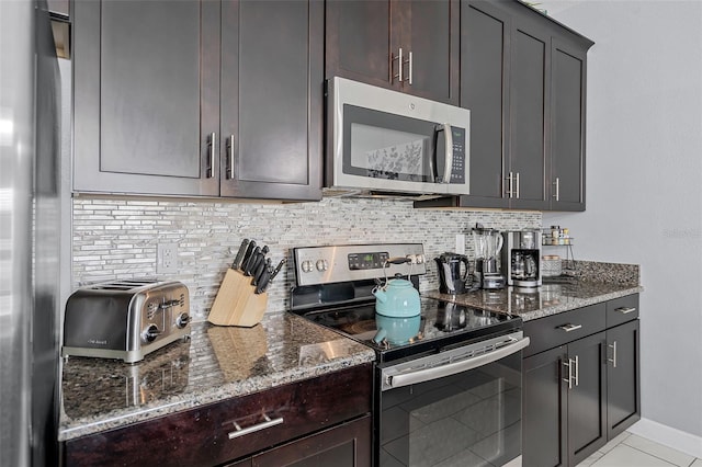 1578 Slice Way, Davenport, FL 33896 - kitchen featuring stainless steel appliances, dark stone counters, and backsplash