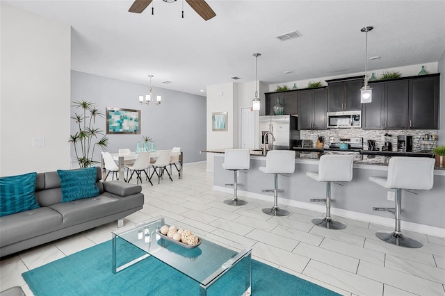 1578 Slice Way, Davenport, FL 33896 - living room with a ceiling fan, a chandelier, and light tile patterned floors