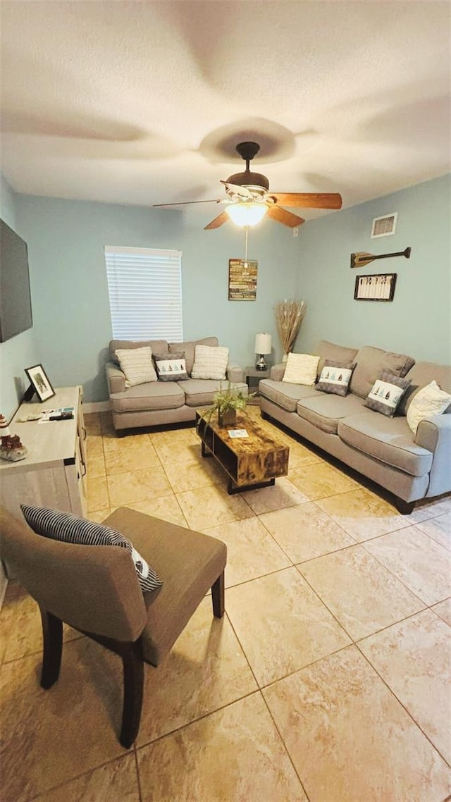 745 17th Ave, Vero Beach, FL 32962 - tiled living room with ceiling fan and a textured ceiling