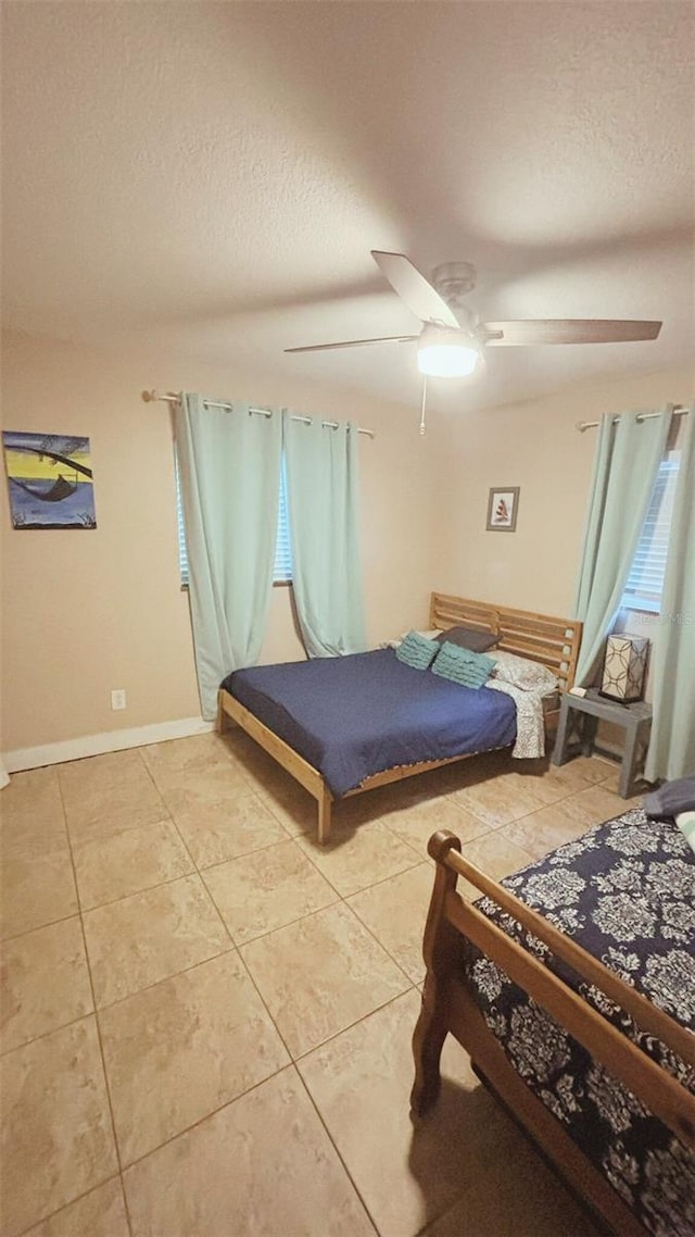 745 17th Ave, Vero Beach, FL 32962 - bedroom with a textured ceiling, light tile patterned floors, and a ceiling fan