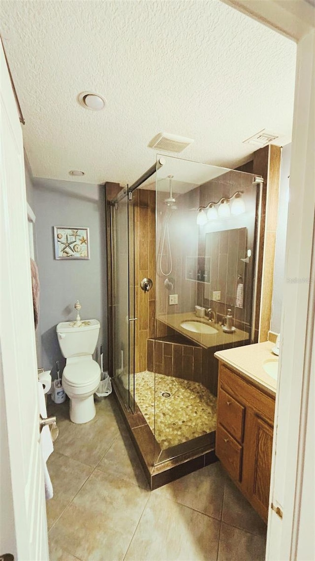 745 17th Ave, Vero Beach, FL 32962 - full bathroom featuring vanity, a stall shower, tile patterned floors, and a textured ceiling
