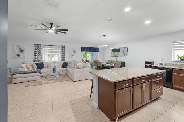 2461 Bulrush Dr, Saint Cloud, FL 34769 - kitchen featuring black dishwasher, light tile patterned floors, open floor plan, a ceiling fan, and a center island