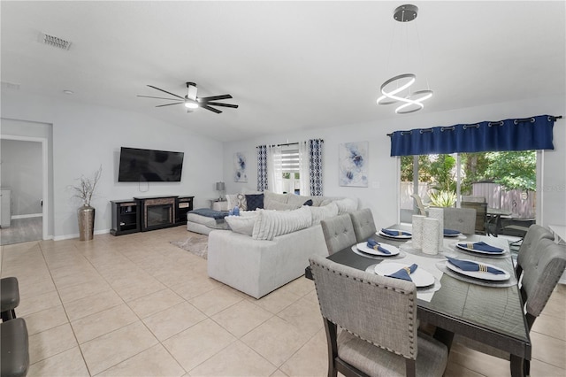 2461 Bulrush Dr, Saint Cloud, FL 34769 - dining room featuring a chandelier, vaulted ceiling, light tile patterned flooring, and ceiling fan