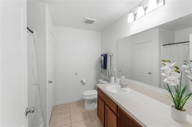 2461 Bulrush Dr, Saint Cloud, FL 34769 - full bathroom with vanity, toilet, tile patterned flooring, a textured ceiling, and baseboards