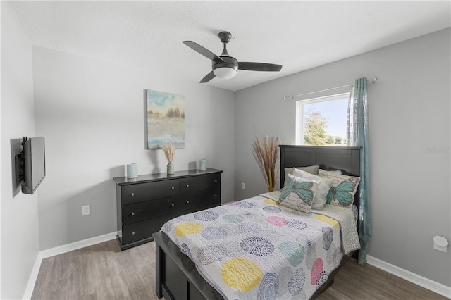 2461 Bulrush Dr, Saint Cloud, FL 34769 - bedroom featuring wood finished floors, baseboards, and a ceiling fan