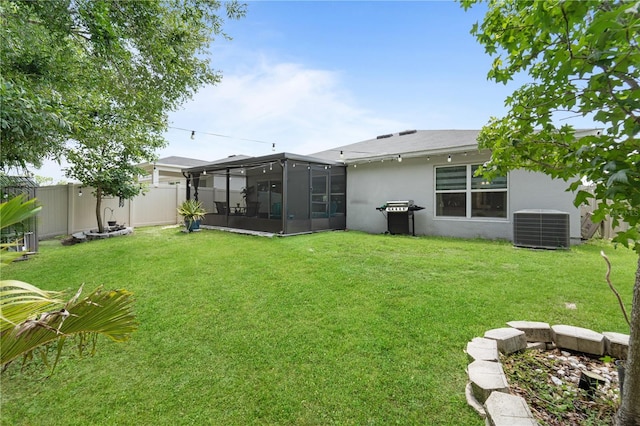 2461 Bulrush Dr, Saint Cloud, FL 34769 - back of property featuring a sunroom, central AC unit, and stucco siding