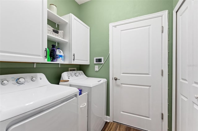1064 Quaker Ridge Ln, Davenport, FL 33896 - laundry room featuring washing machine and clothes dryer, cabinet space, and dark wood-style flooring