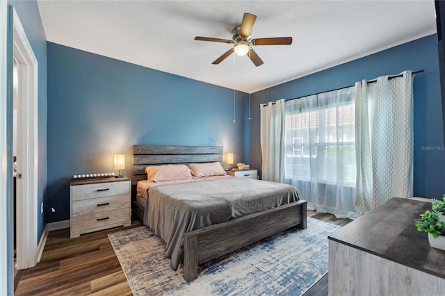 1064 Quaker Ridge Ln, Davenport, FL 33896 - bedroom with dark wood-style flooring, a ceiling fan, and baseboards