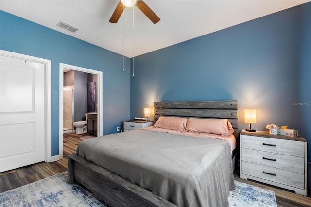 1064 Quaker Ridge Ln, Davenport, FL 33896 - bedroom with wood finished floors, ensuite bathroom, baseboards, and a ceiling fan