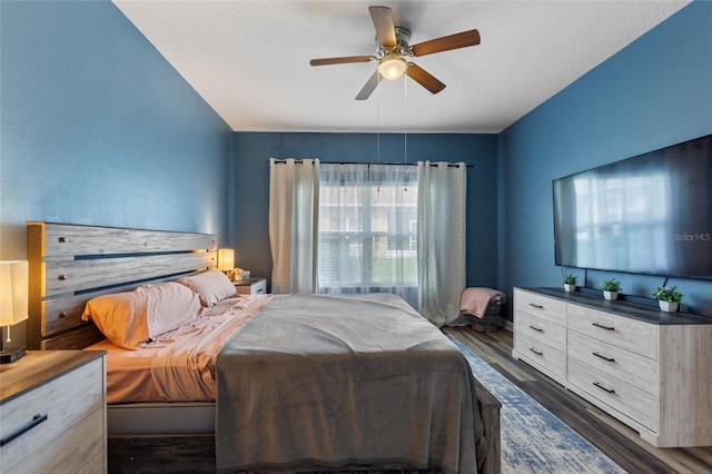 1064 Quaker Ridge Ln, Davenport, FL 33896 - bedroom with dark wood-style floors and a ceiling fan