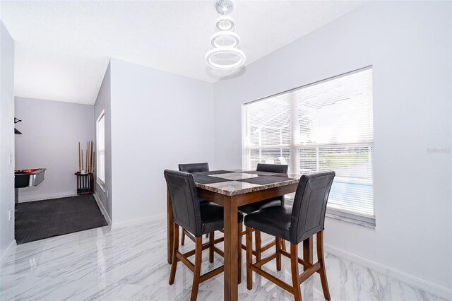 2503 Calla Lily Cv, Kissimmee, FL 34758 - dining area featuring baseboards and light marble finish floors