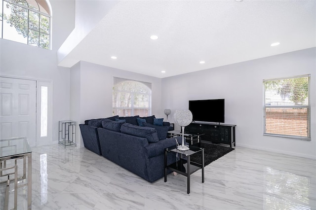 2503 Calla Lily Cv, Kissimmee, FL 34758 - living room featuring marble tiled flooring, healthy amount of natural light, recessed lighting, a textured ceiling, and baseboards