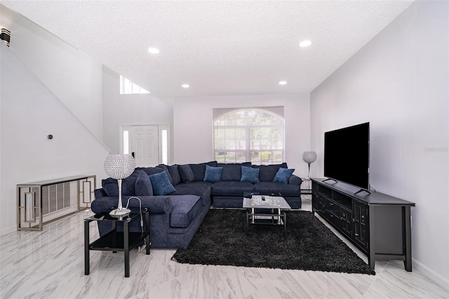 2503 Calla Lily Cv, Kissimmee, FL 34758 - living area featuring a textured ceiling, recessed lighting, light marble finish flooring, and baseboards