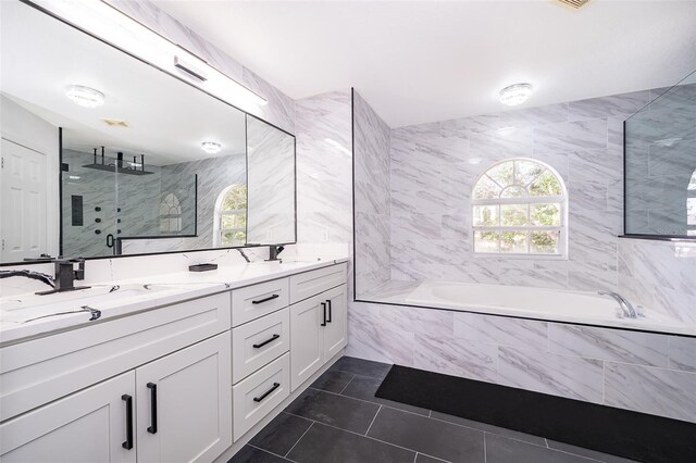 2503 Calla Lily Cv, Kissimmee, FL 34758 - full bathroom featuring a garden tub, tile walls, double vanity, healthy amount of natural light, and a stall shower