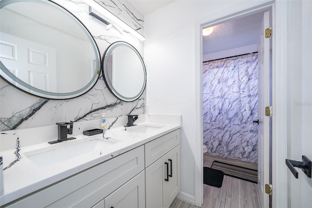 2503 Calla Lily Cv, Kissimmee, FL 34758 - full bath with double vanity, toilet, decorative backsplash, and wood finished floors