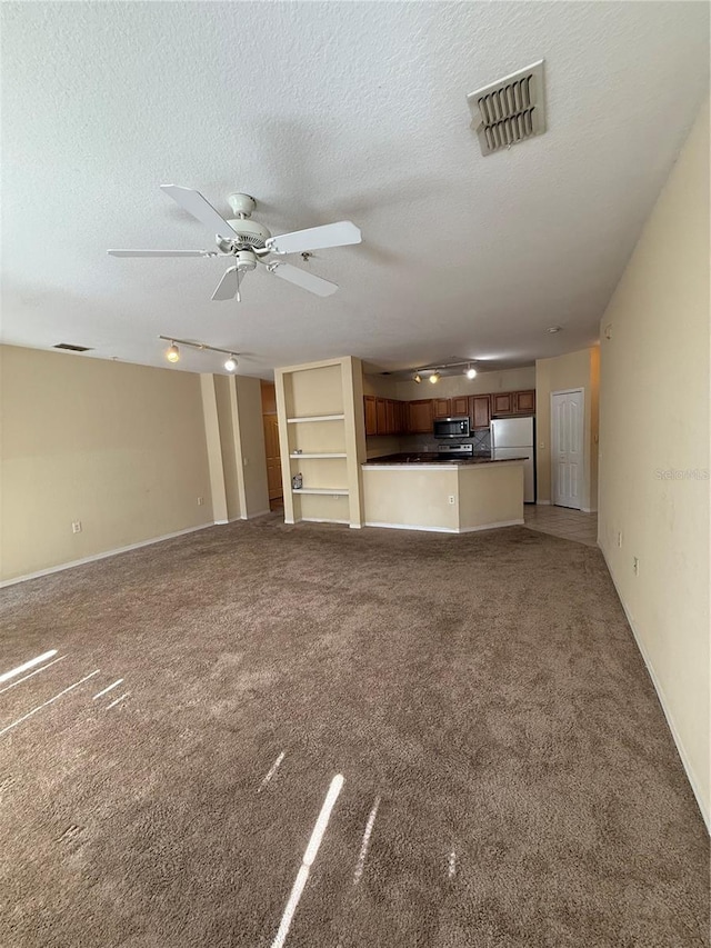 6169 Metrowest Blvd Unit 208, Orlando, FL 32835 - unfurnished living room featuring light carpet, a textured ceiling, and ceiling fan