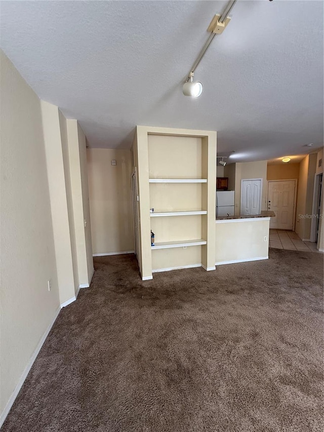 6169 Metrowest Blvd Unit 208, Orlando, FL 32835 - unfurnished living room featuring carpet floors and a textured ceiling