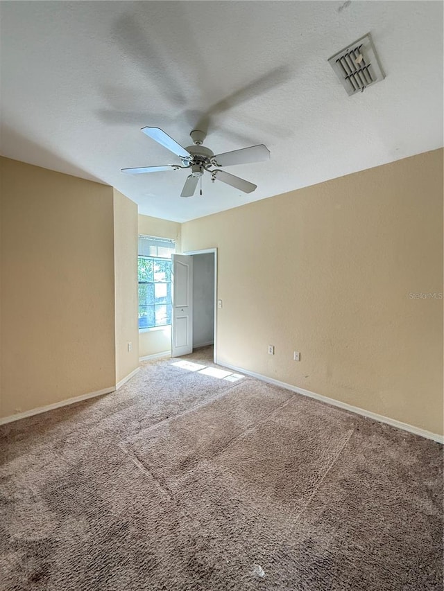 6169 Metrowest Blvd Unit 208, Orlando, FL 32835 - empty room with ceiling fan, light carpet, and a textured ceiling