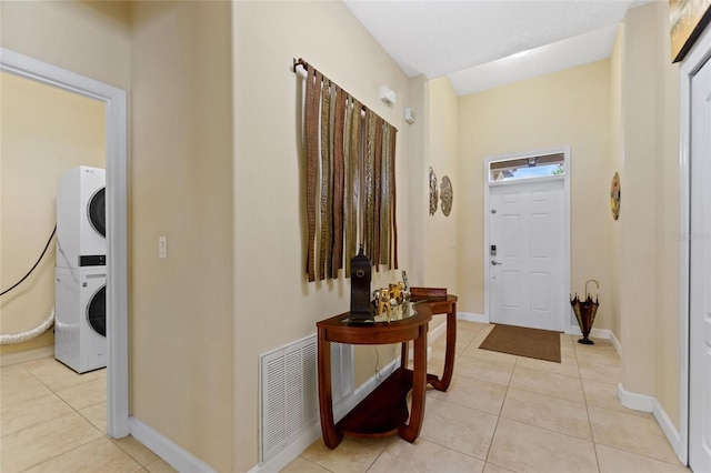 1353 Palmetto Dunes St, Davenport, FL 33836 - entrance foyer featuring stacked washer / dryer and light tile patterned floors